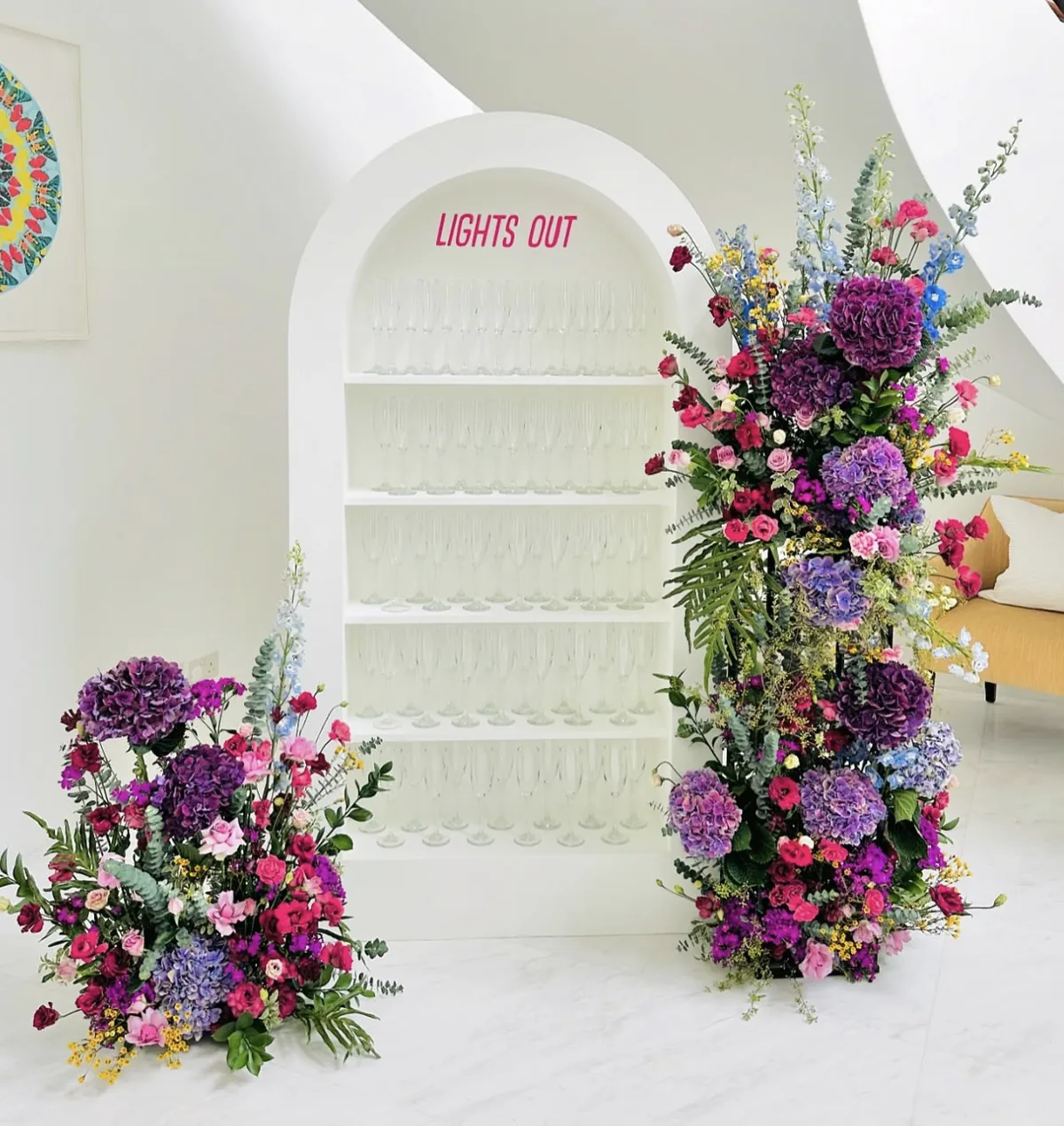 Champagne wall with floral installation