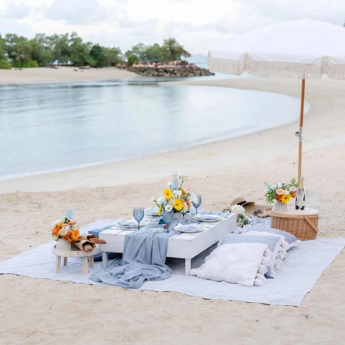 Luxe beach picnic with low table and cushions